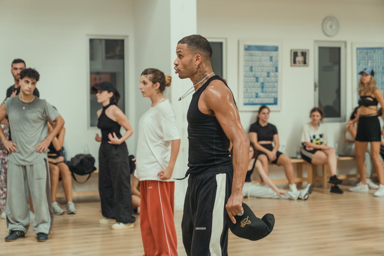 Dynamic dance class indoors, showcasing diverse adults engaged in energetic practice.